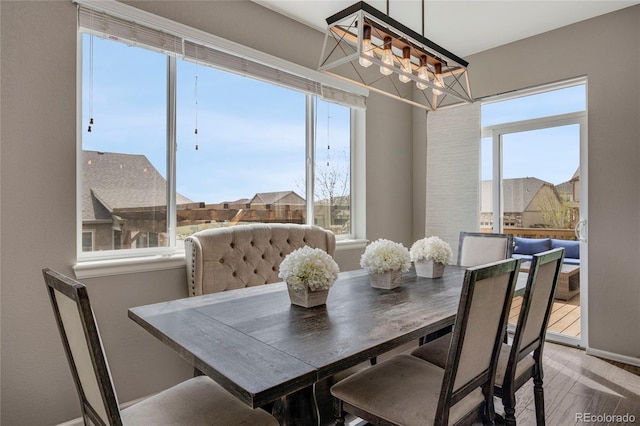 dining room with baseboards and a notable chandelier