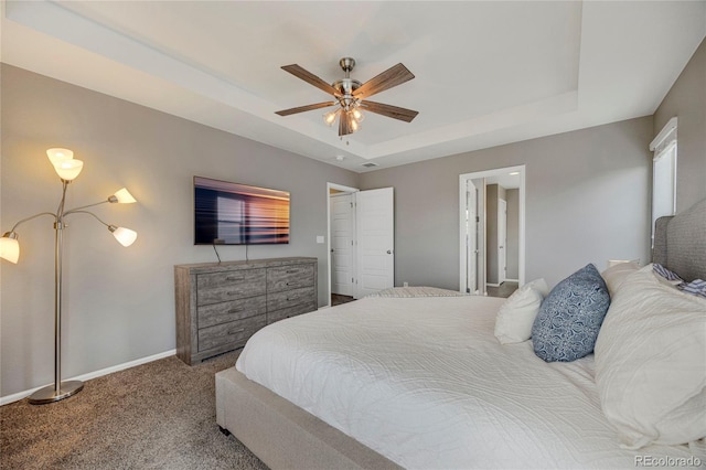 bedroom featuring a raised ceiling, baseboards, carpet flooring, and ceiling fan