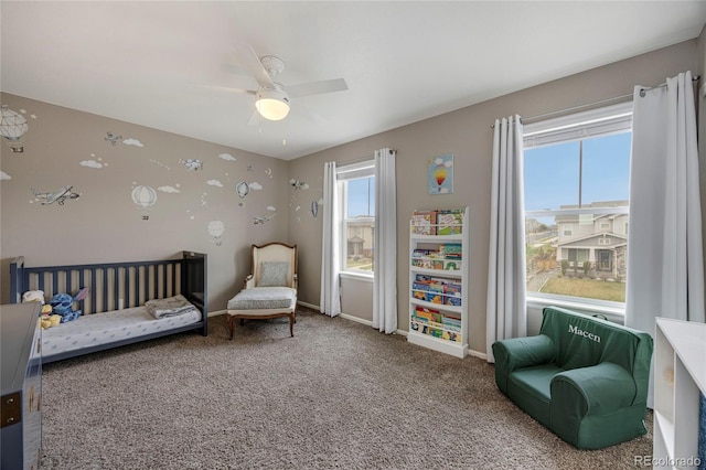 bedroom featuring baseboards, carpet, ceiling fan, and multiple windows