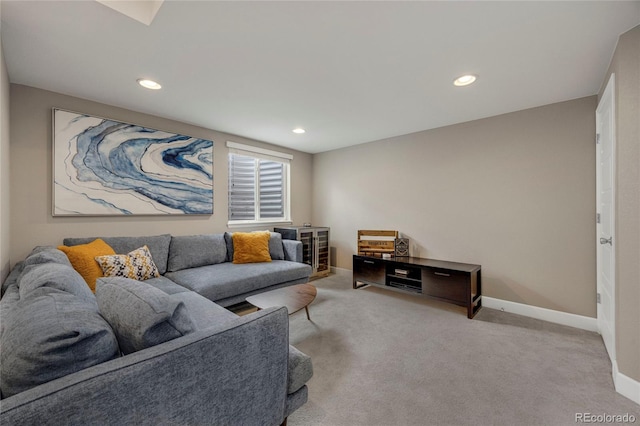 carpeted living room featuring baseboards and recessed lighting