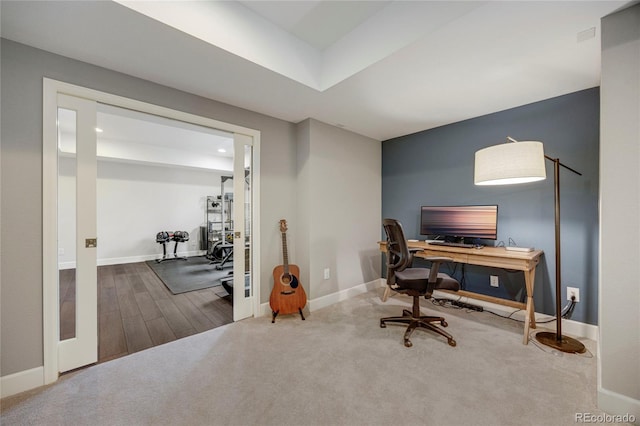 office space featuring baseboards and wood finished floors