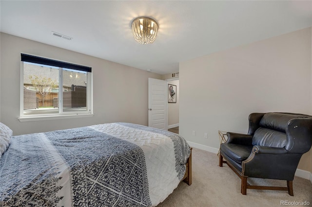 bedroom with baseboards, visible vents, and carpet