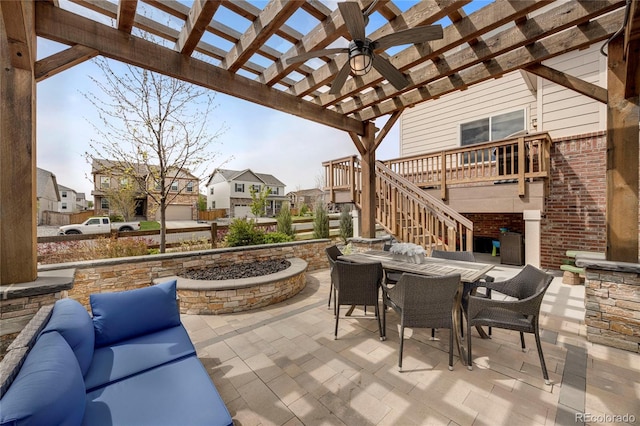 view of patio with a residential view, a pergola, a deck, stairway, and outdoor dining area