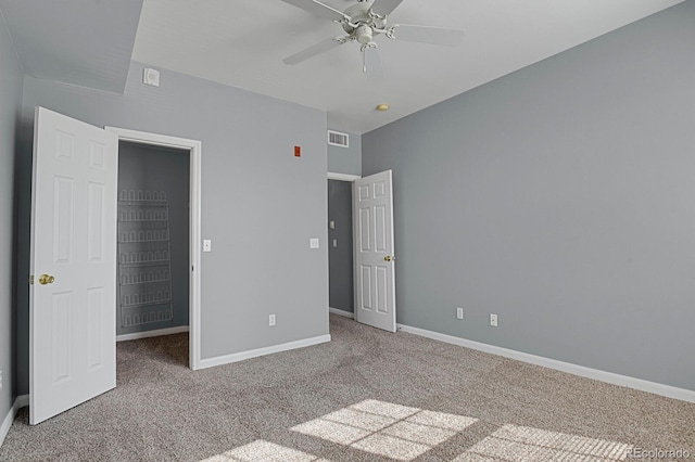 unfurnished bedroom with carpet, visible vents, and baseboards