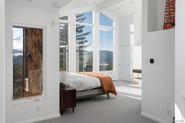 carpeted bedroom featuring lofted ceiling with beams