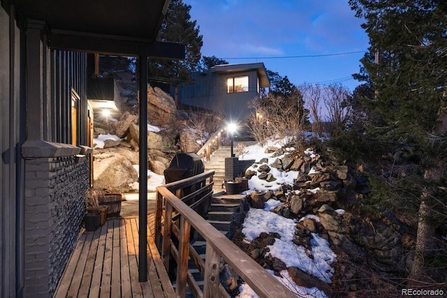 snow covered deck featuring a grill