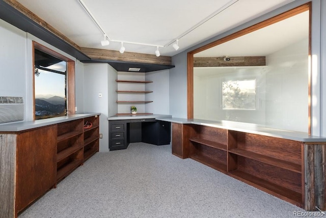 home office featuring light carpet and built in desk