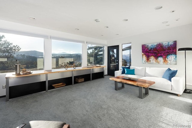 living area featuring recessed lighting, carpet floors, and a mountain view