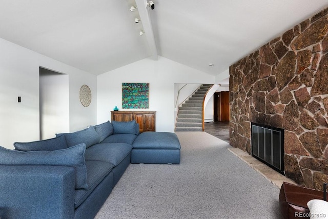 living room featuring carpet floors, lofted ceiling with beams, a fireplace, and stairs