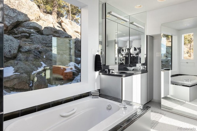 full bathroom with a garden tub, backsplash, and vanity