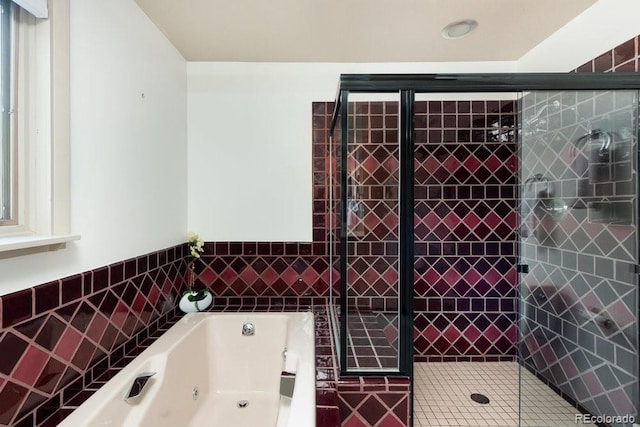 full bathroom with a tub with jets and a stall shower