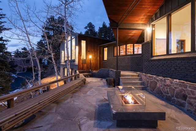 view of patio / terrace featuring an outdoor fire pit