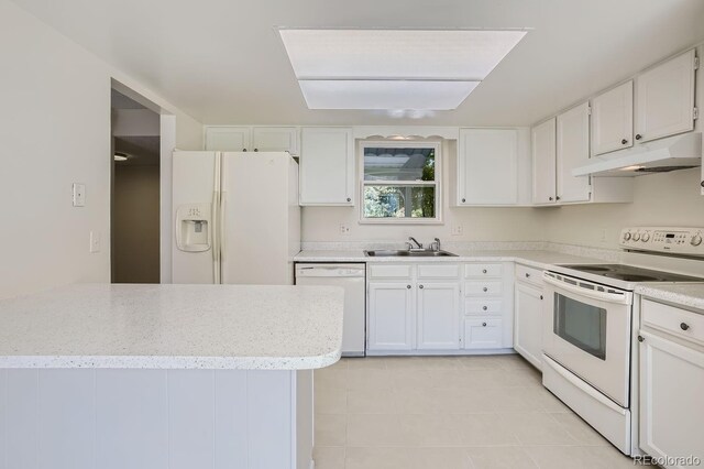 kitchen featuring light tile patterned floors, white cabinets, sink, and white appliances