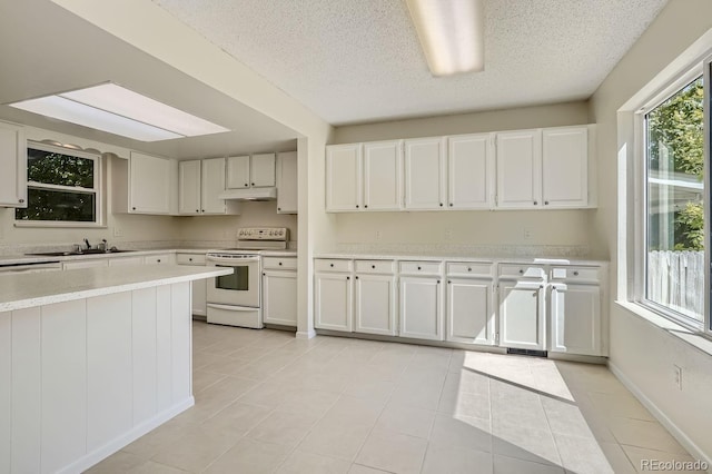 kitchen with a textured ceiling, sink, white cabinets, light tile patterned floors, and white range with electric cooktop