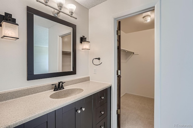 bathroom featuring a textured ceiling and vanity