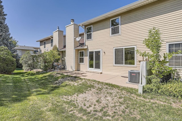 back of property featuring a patio and a yard