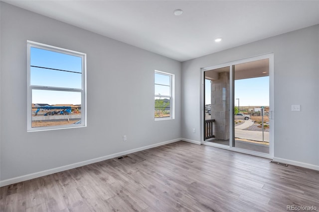 unfurnished room with light hardwood / wood-style floors