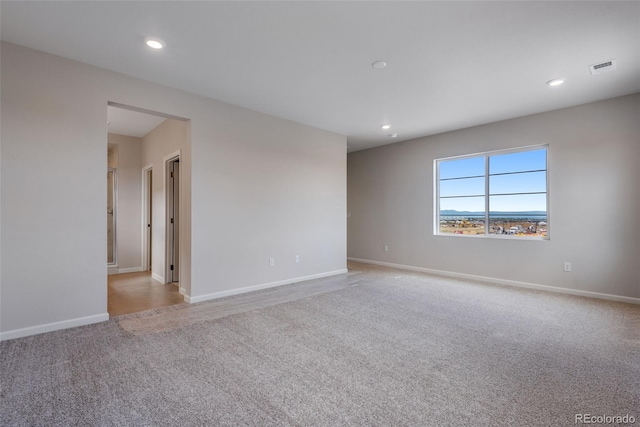 spare room with light colored carpet