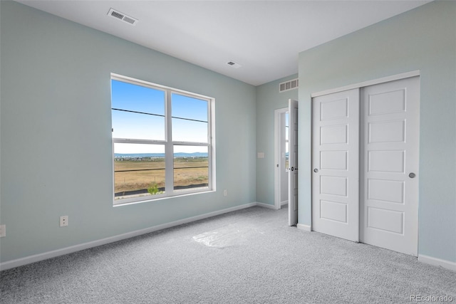 unfurnished bedroom with a closet and carpet