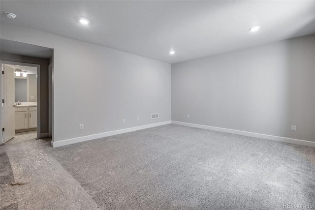 carpeted spare room with sink