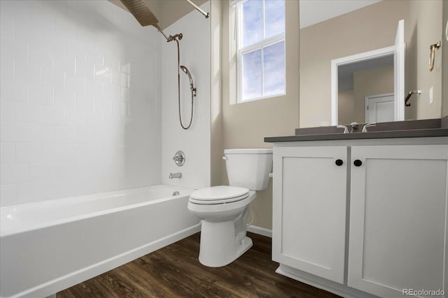 full bathroom with vanity, wood-type flooring, toilet, and tiled shower / bath