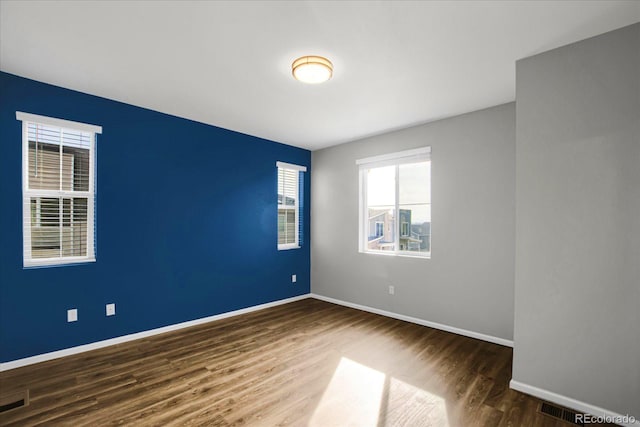 unfurnished room featuring dark hardwood / wood-style floors