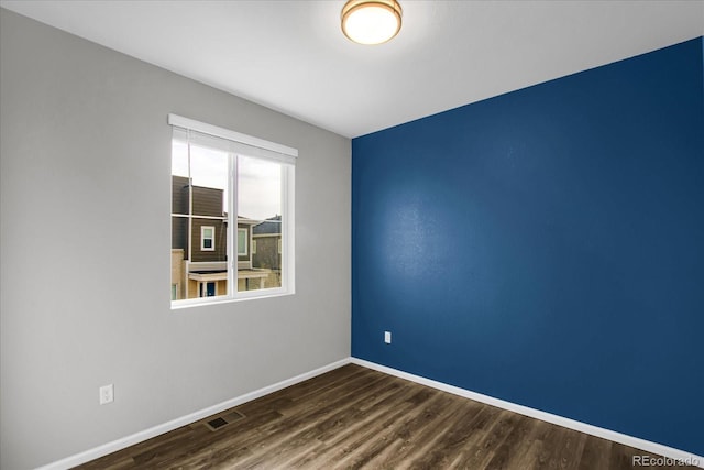 empty room featuring dark hardwood / wood-style flooring