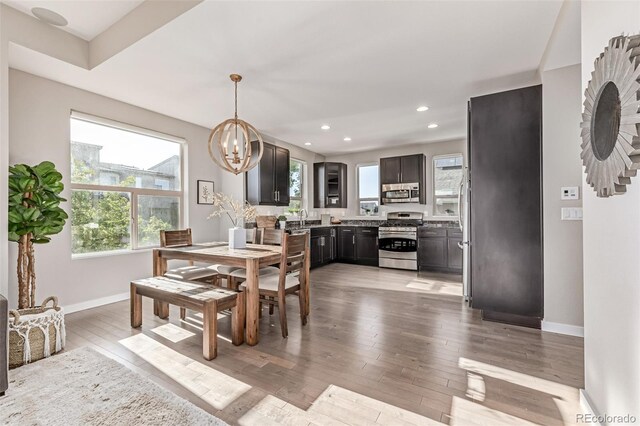 10305 Martin Luther King Blvd, Denver, CO 80238 - dining area with a chandelier, baseboards, light wood-type flooring, and recessed lighting
