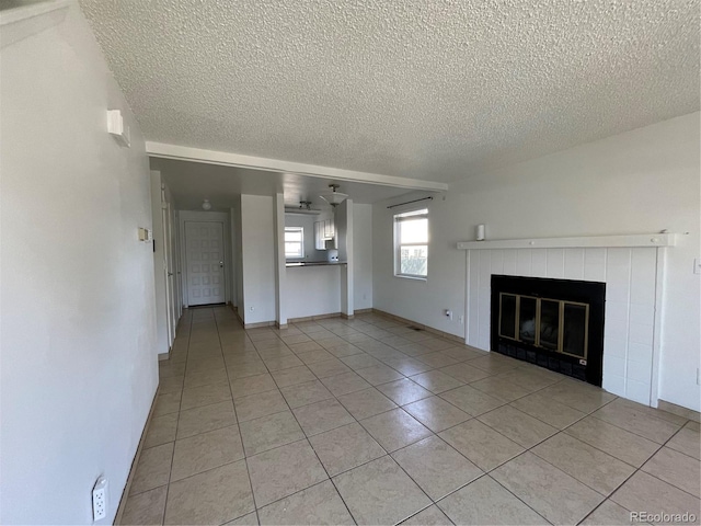 16485 E 17th Pl Unit D, Aurora, CO 80011 - unfurnished living room featuring light tile patterned floors, a textured ceiling, a tiled fireplace, and ceiling fan