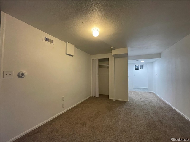 16485 E 17th Pl Unit D, Aurora, CO 80011 - unfurnished bedroom featuring carpet flooring, a closet, and a textured ceiling