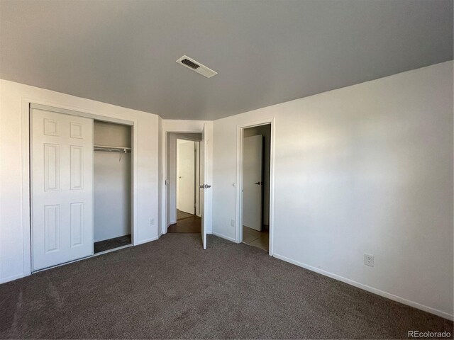 16485 E 17th Pl Unit D, Aurora, CO 80011 - unfurnished bedroom featuring dark carpet and a closet