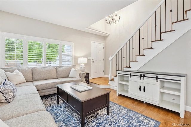 1449 Braewood Ave, Highlands Ranch, CO 80129 - living room featuring stairway, light wood-style flooring, a chandelier, and baseboards