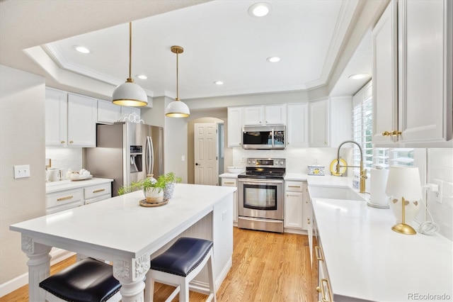1449 Braewood Ave, Highlands Ranch, CO 80129 - kitchen featuring stainless steel appliances, a sink, arched walkways, a kitchen bar, and recessed lighting