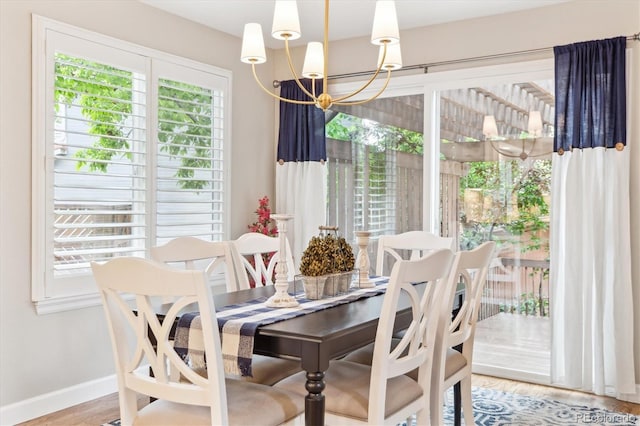 1449 Braewood Ave, Highlands Ranch, CO 80129 - dining space with a chandelier, baseboards, and wood finished floors
