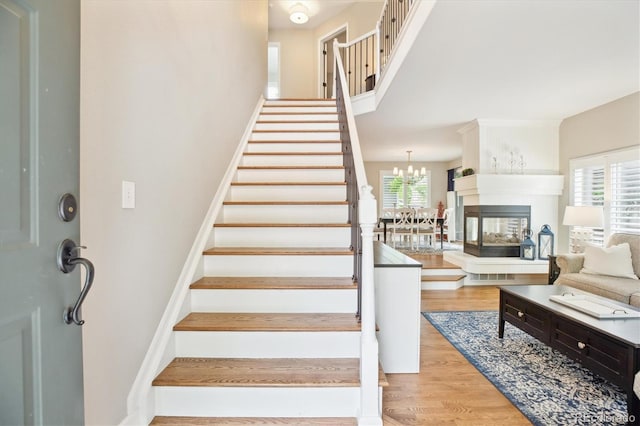 1449 Braewood Ave, Highlands Ranch, CO 80129 - stairs featuring wood finished floors and a chandelier