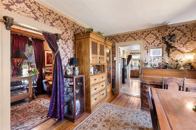 310 E Whiting Ave, Cripple Creek, CO 80813 - dining area featuring wallpapered walls, hardwood / wood-style flooring, and ornamental molding