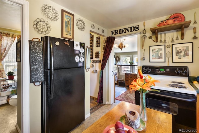 310 E Whiting Ave, Cripple Creek, CO 80813 - kitchen with electric range oven, freestanding refrigerator, and carpet flooring