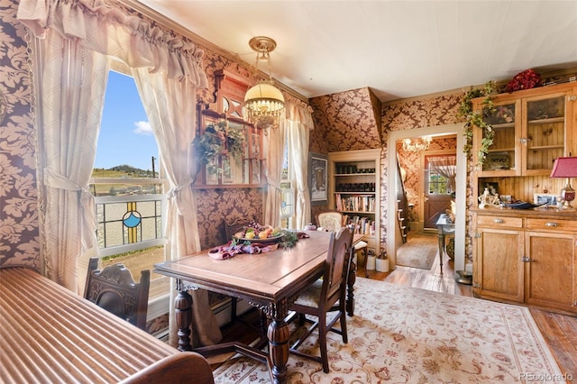 310 E Whiting Ave, Cripple Creek, CO 80813 - dining area with a chandelier, wood finished floors, and wallpapered walls