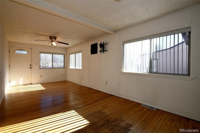 empty room featuring hardwood / wood-style flooring, plenty of natural light, and ceiling fan