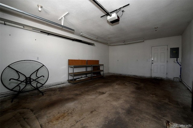 garage with a garage door opener and electric panel