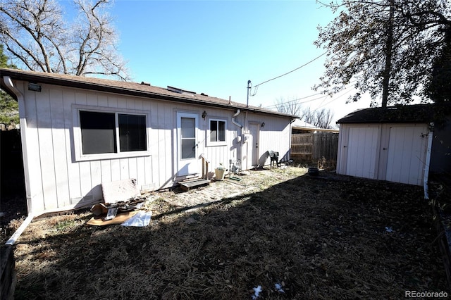 rear view of house with a storage unit