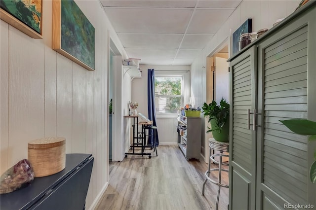 interior space featuring wooden walls and light wood-type flooring