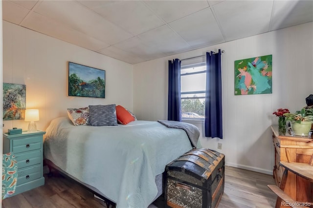 bedroom with wood finished floors and baseboards