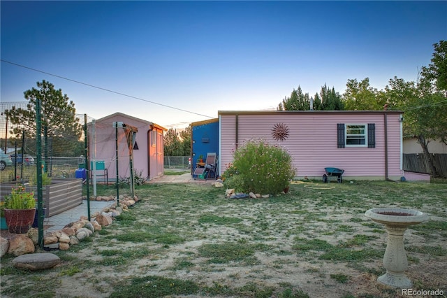 view of yard featuring fence and an outdoor structure