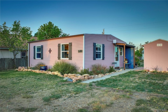exterior space featuring an outbuilding and fence