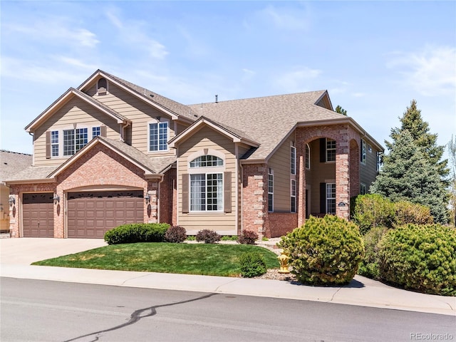 view of front of home with a garage and a front lawn