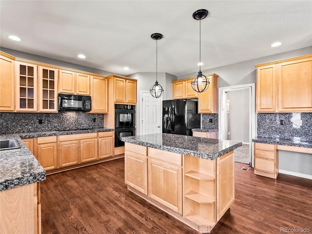 kitchen with hanging light fixtures, a center island, light brown cabinetry, and black appliances