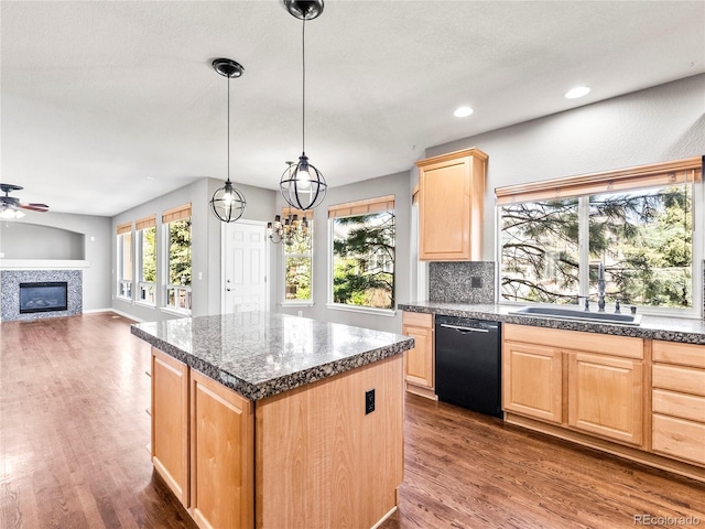 kitchen featuring hanging light fixtures, dark hardwood / wood-style floors, black dishwasher, a kitchen island, and light brown cabinets