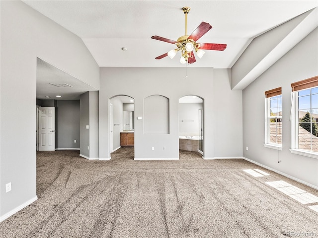 unfurnished living room featuring ceiling fan, lofted ceiling, and carpet flooring