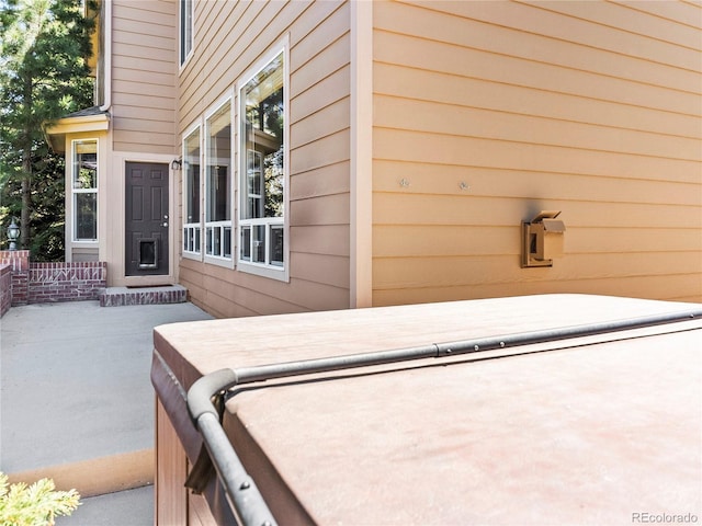 view of patio / terrace with a covered hot tub